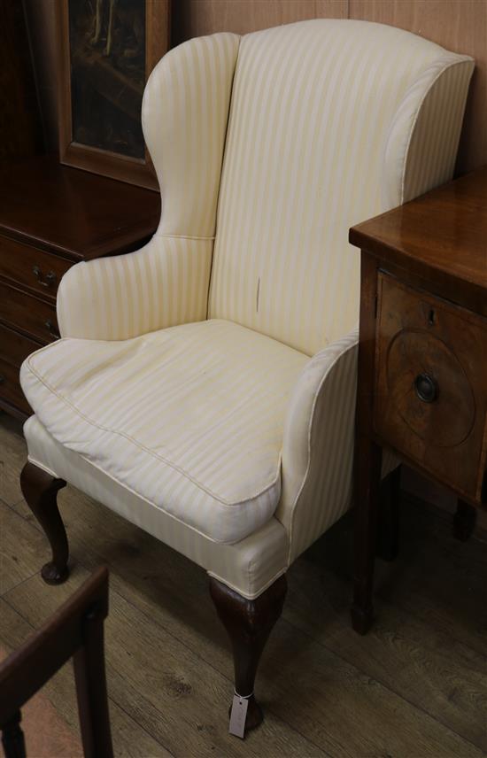 An upholstered wing armchair